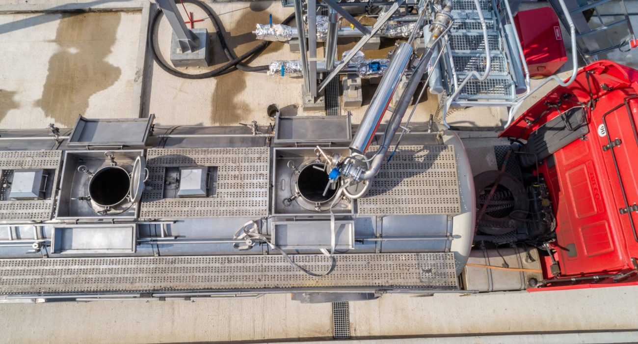 pouring chemical components into a tanker at the factory