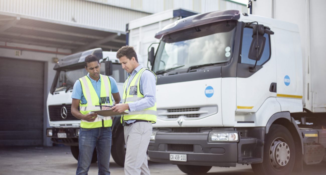 Workers loading a lorry at a large warehouse