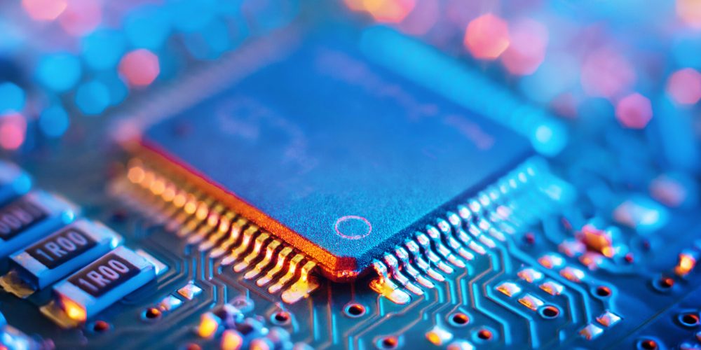 Computer Microchips and Processors on Electronic circuit board. Abstract technology microelectronics concept background. Macro shot, shallow focus.